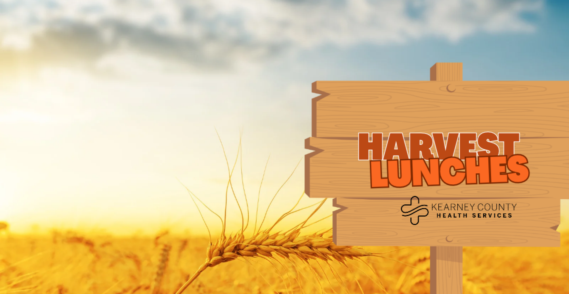 harvest lunches logo on sign in field