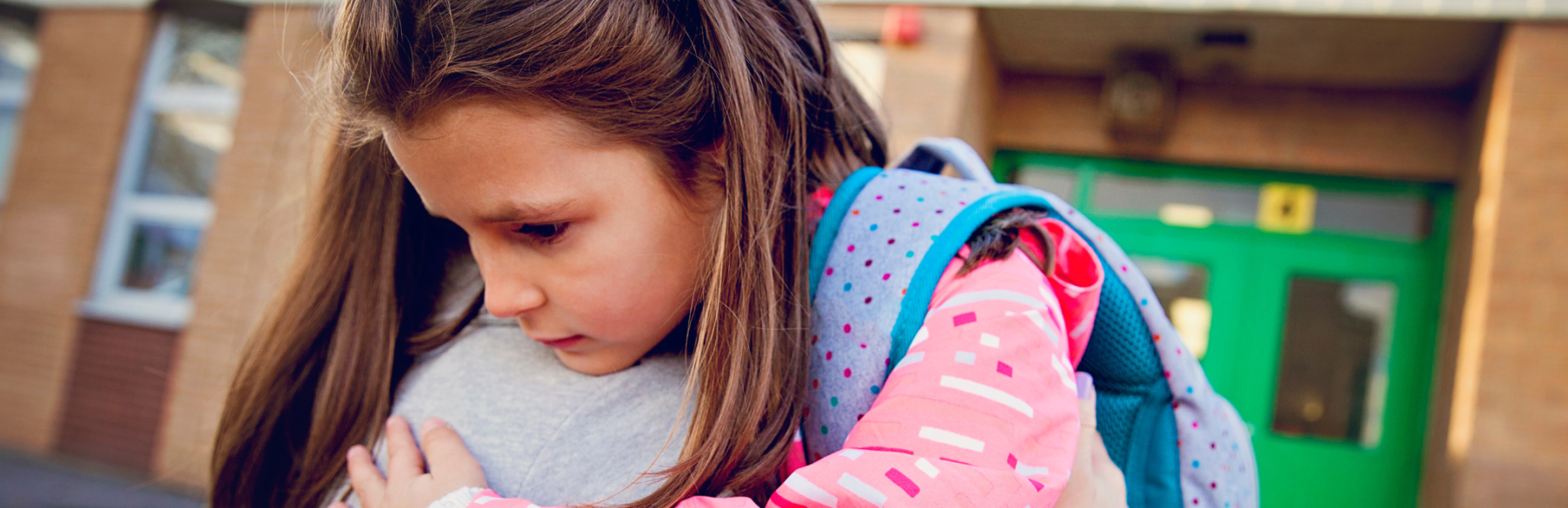 parent hugging child at school