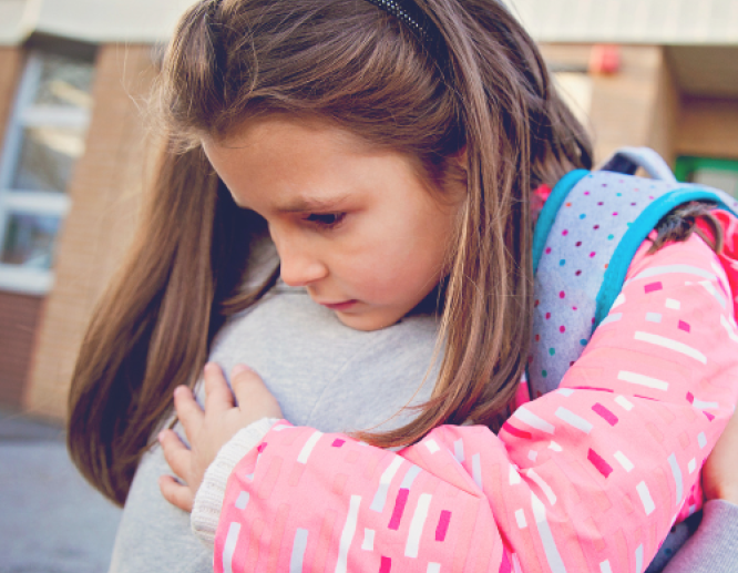 parent hugging child at school