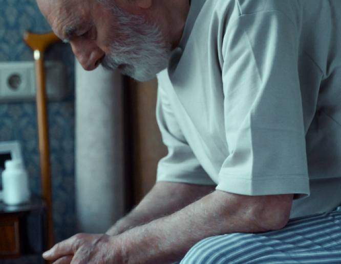 Senior Man on edge of bed