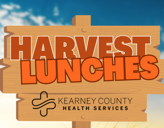 harvest lunches logo on sign in field