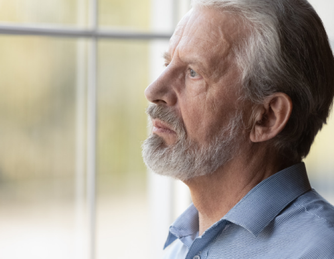 man looking out window